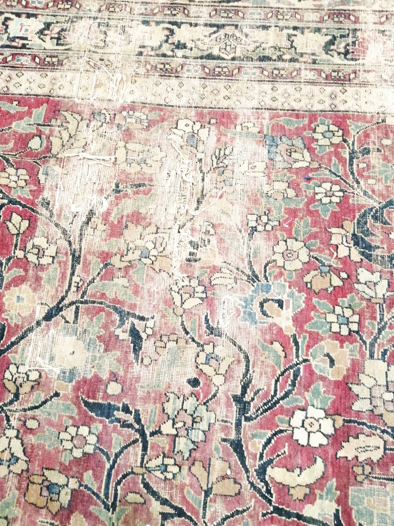 An antique Kashan blue ground carpet (worn and holed) 410 x 300cm